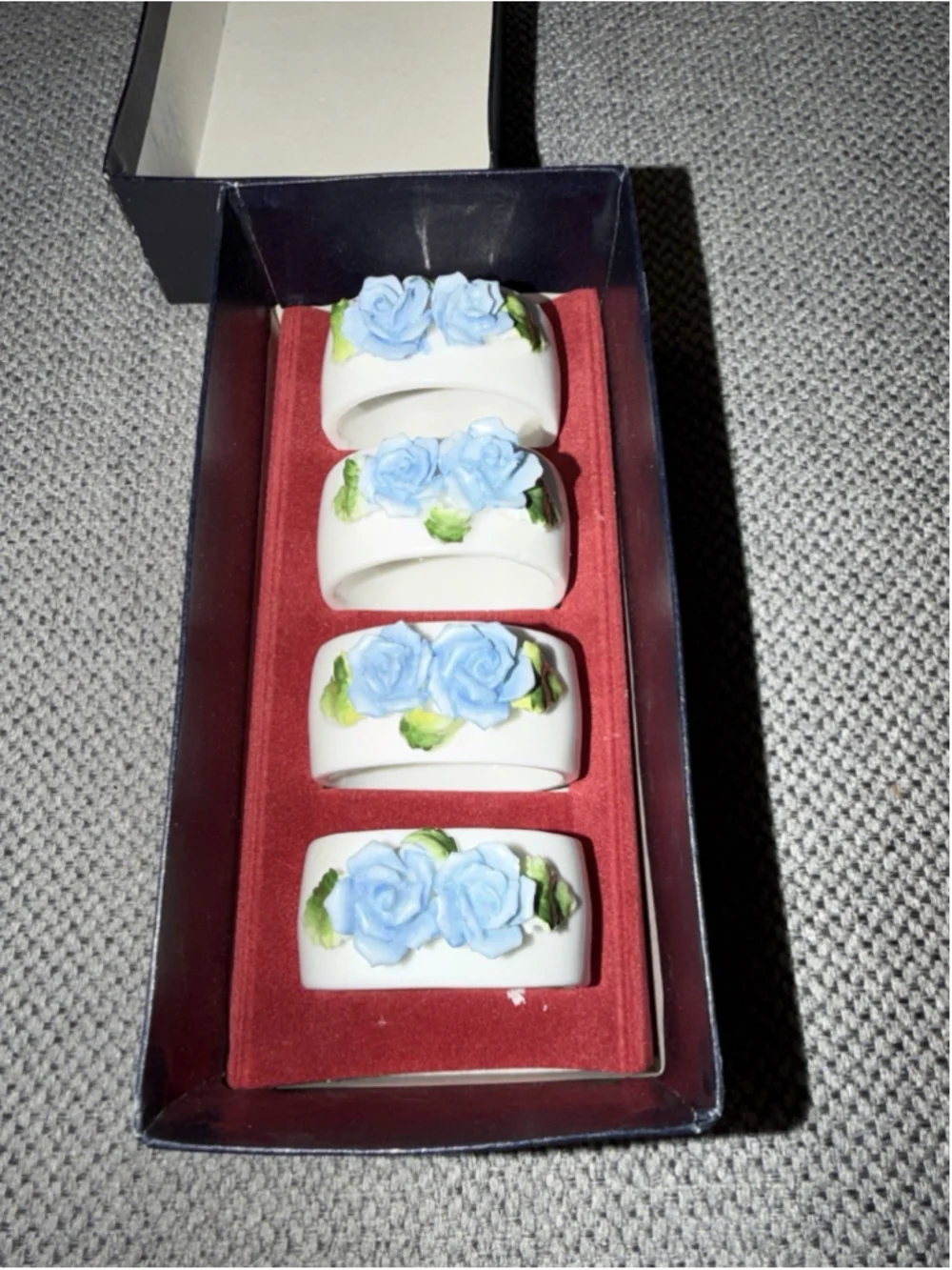 vintage porcelain napkin rings featuring applied blue rose bouquets